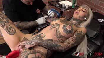 Beautiful busty blonde uses a toy while having her arm tattooed video